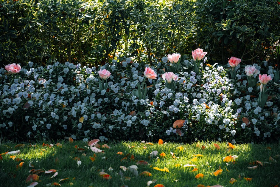 Lush garden with pink tulips and white flowers in full bloom during spring.